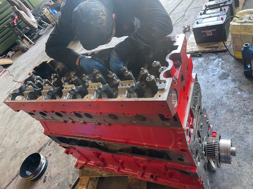 Mechanic working on diesel engine at Baja Diesel